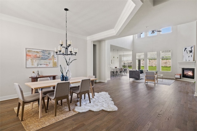 dining room with an inviting chandelier, dark wood-type flooring, and ornamental molding