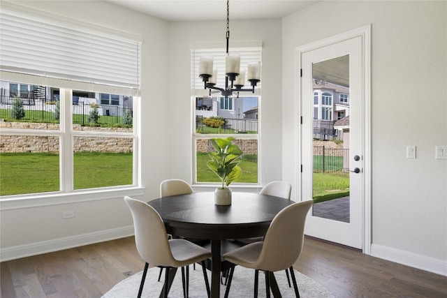 dining room with hardwood / wood-style floors and a chandelier