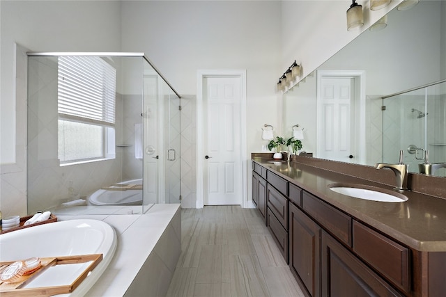 bathroom featuring dual vanity, tile patterned floors, and plus walk in shower