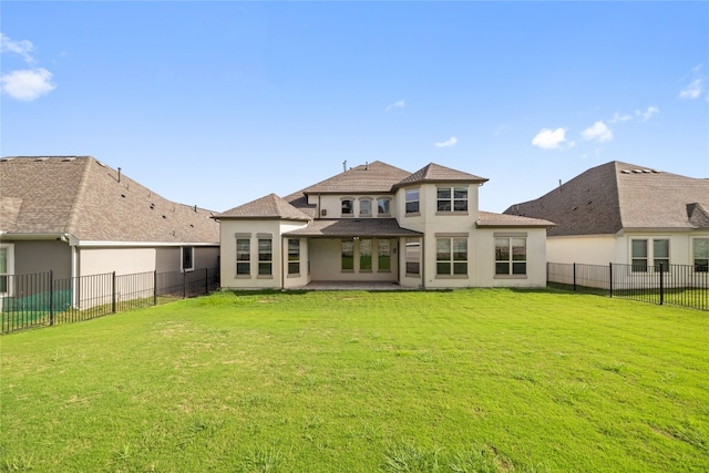 rear view of house featuring a yard