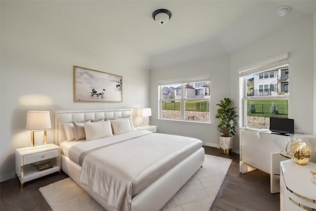 bedroom with dark hardwood / wood-style flooring