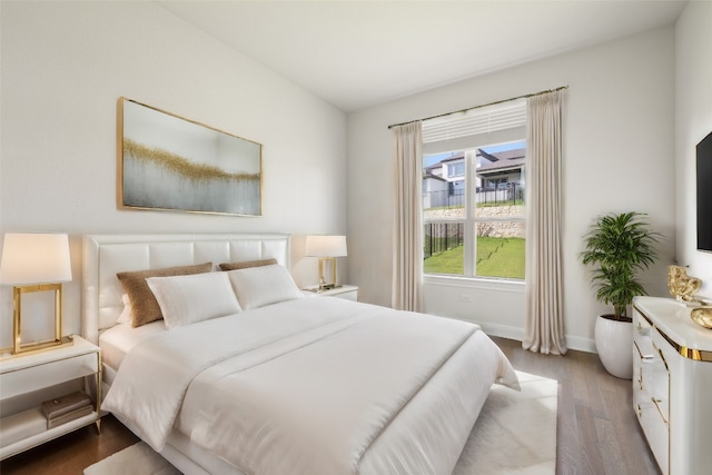 bedroom with hardwood / wood-style flooring