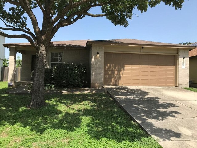 single story home featuring a front yard and a garage