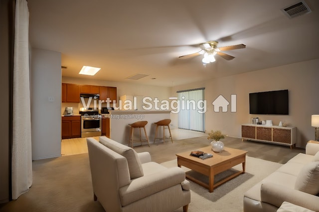 living room with ceiling fan and light carpet