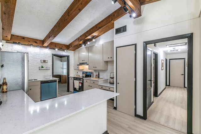 kitchen with lofted ceiling with beams, light wood-type flooring, kitchen peninsula, stainless steel appliances, and brick wall