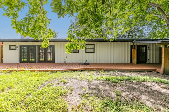 back of property with a deck and french doors