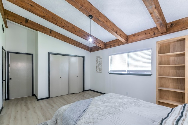 bedroom featuring light wood-type flooring, vaulted ceiling with beams, and a closet