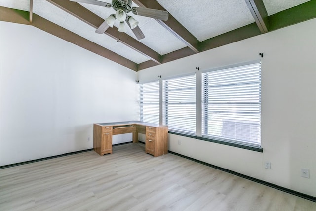 empty room featuring a textured ceiling, light hardwood / wood-style floors, lofted ceiling with beams, and ceiling fan