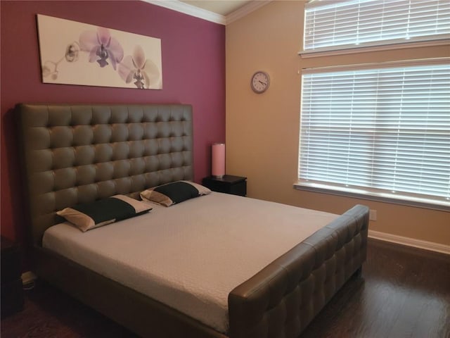 bedroom featuring dark wood-type flooring and ornamental molding