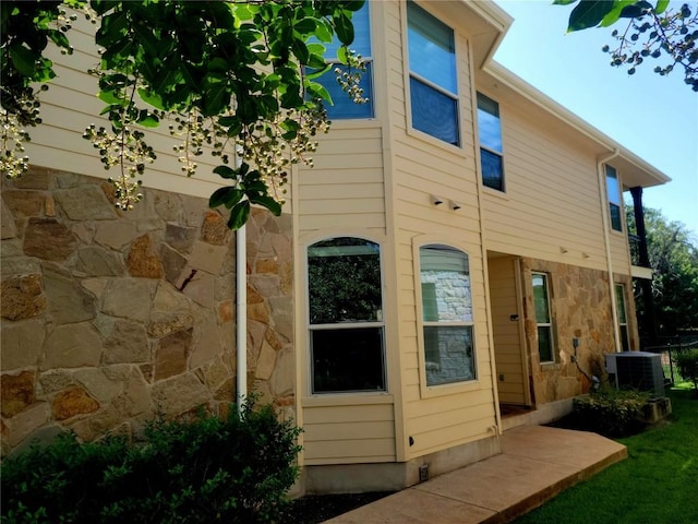 rear view of property with central AC