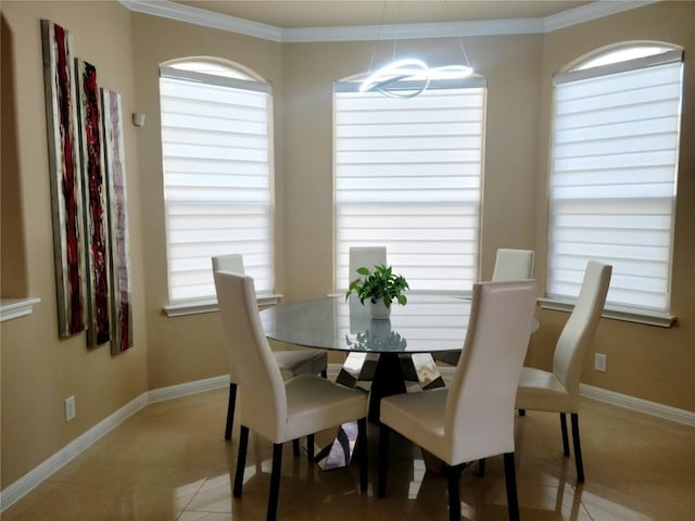 dining space with light tile patterned floors and ornamental molding