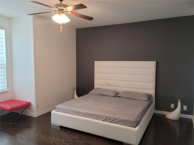 bedroom with ceiling fan, dark hardwood / wood-style floors, and multiple windows