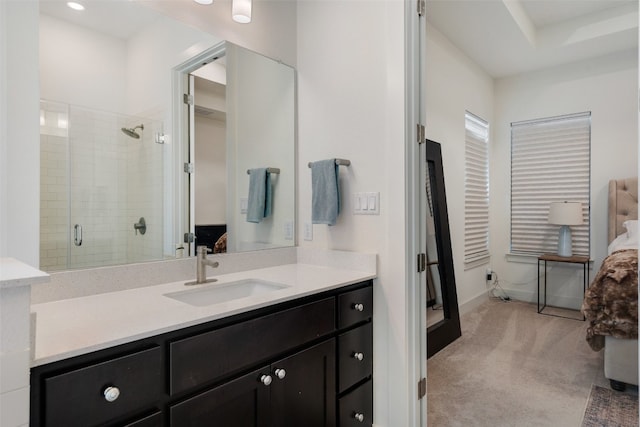 bathroom with vanity and a shower with door