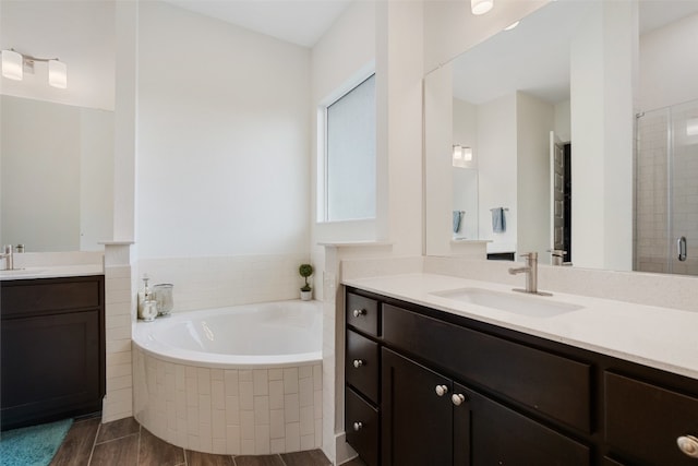 bathroom featuring vanity, wood-type flooring, and independent shower and bath