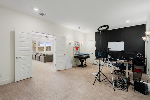 carpeted office featuring ceiling fan