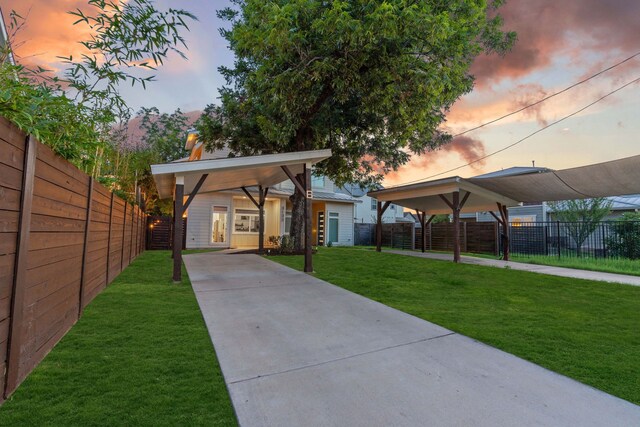 exterior space with a lawn and a carport