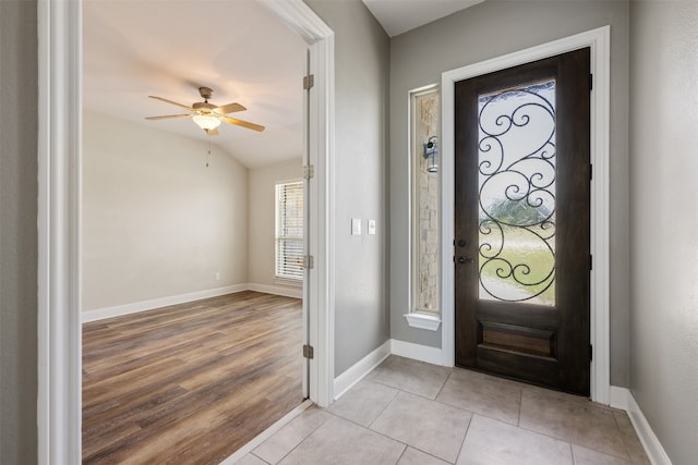 foyer featuring lofted ceiling, light wood-type flooring, and ceiling fan