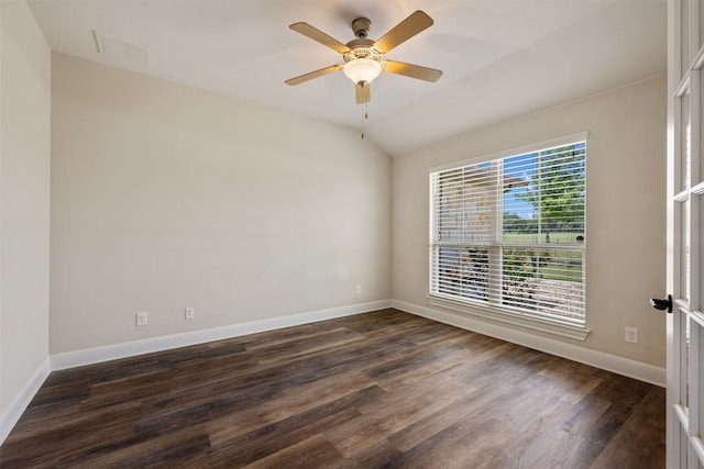 spare room featuring lofted ceiling, dark wood-type flooring, and ceiling fan