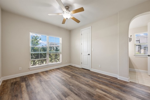 empty room featuring ceiling fan and dark hardwood / wood-style flooring