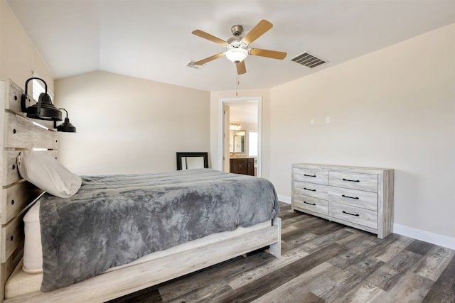 bedroom featuring lofted ceiling, dark hardwood / wood-style floors, connected bathroom, and ceiling fan