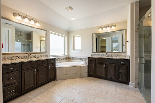 bathroom featuring vanity, shower with separate bathtub, and tile patterned flooring