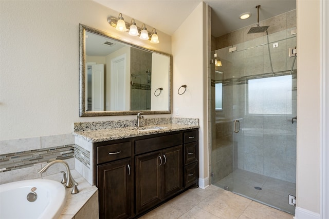 bathroom featuring vanity, tile patterned floors, and separate shower and tub