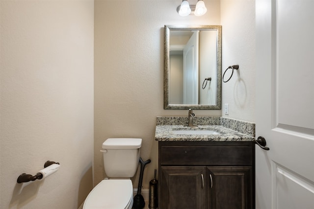 bathroom with toilet and vanity