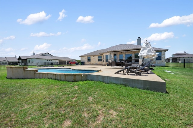 view of pool with a patio area and a yard