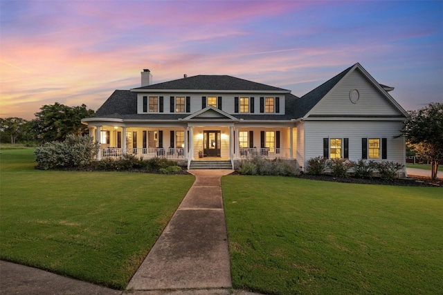 view of front of house with covered porch and a lawn