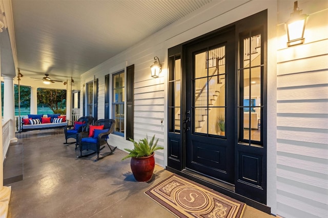 entrance to property with ceiling fan and covered porch