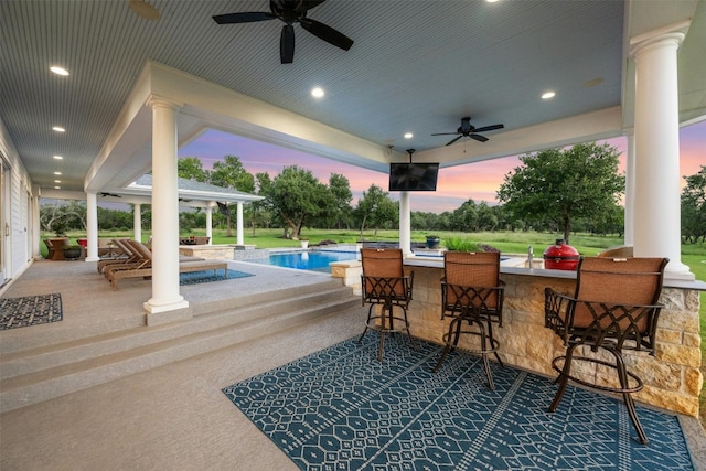 view of patio / terrace featuring a pool with hot tub, an outdoor bar, and ceiling fan