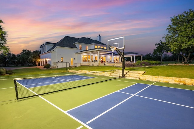 exterior space with basketball court and a yard