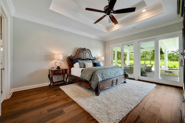 bedroom with crown molding, ceiling fan, hardwood / wood-style floors, and a tray ceiling