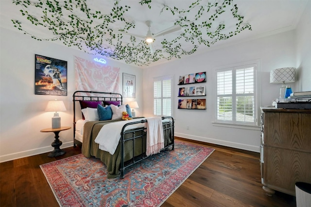 bedroom featuring ceiling fan, dark hardwood / wood-style flooring, and ornamental molding