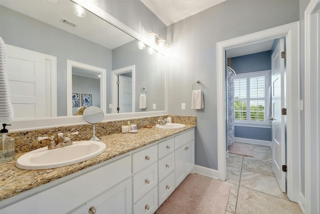 bathroom featuring tile patterned floors and double sink vanity