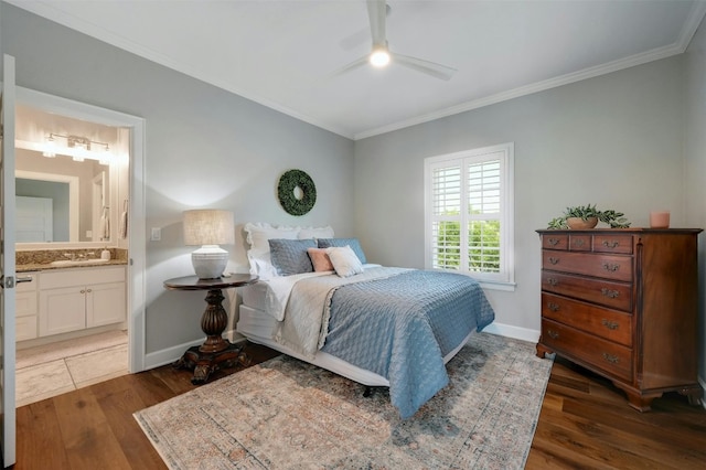 bedroom featuring crown molding, connected bathroom, dark hardwood / wood-style flooring, and ceiling fan