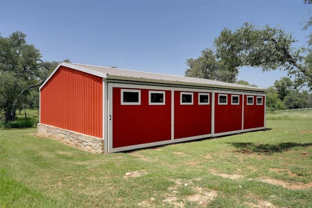 view of outbuilding featuring a yard