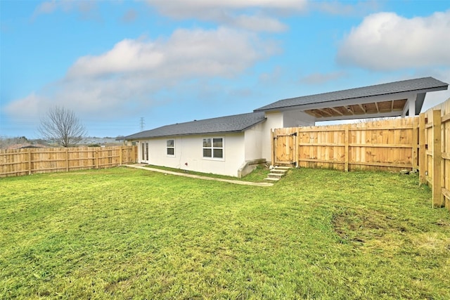 rear view of house featuring a yard