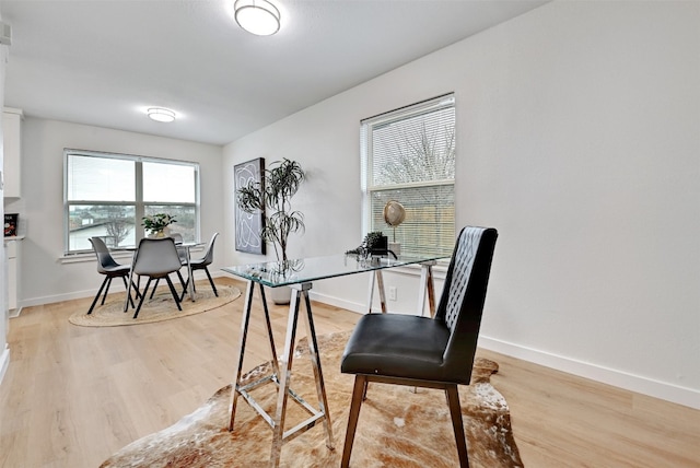 office area with light hardwood / wood-style floors