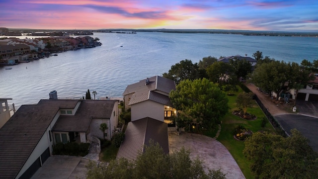 aerial view at dusk with a water view