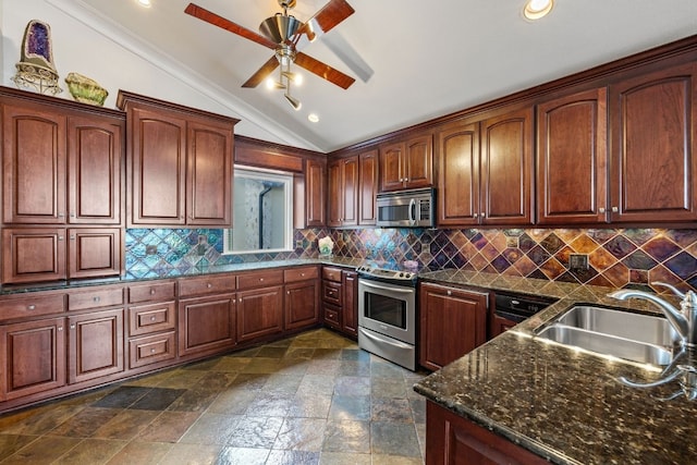 kitchen featuring ceiling fan, stainless steel appliances, vaulted ceiling, sink, and ornamental molding