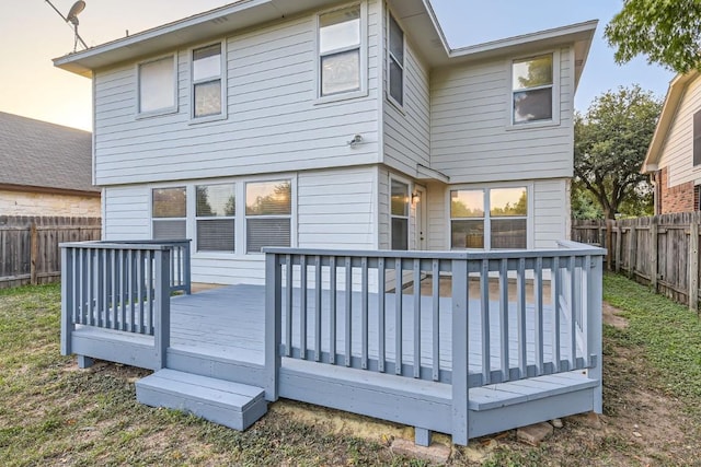 rear view of property featuring a wooden deck