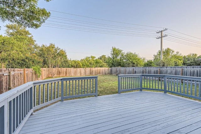 wooden deck featuring a yard