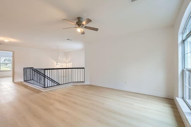 unfurnished room with ceiling fan and light wood-type flooring