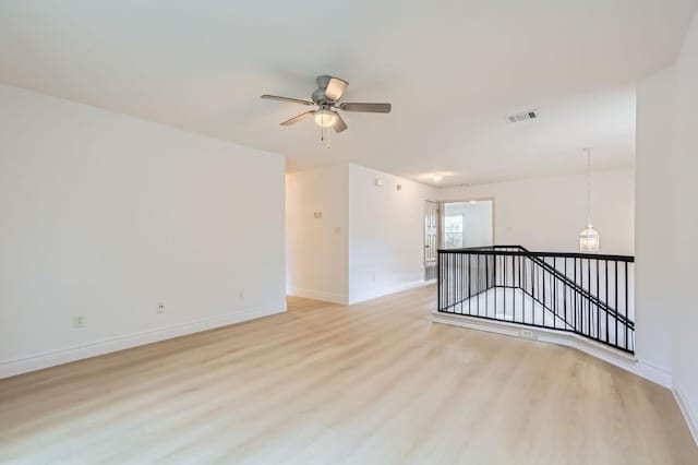 spare room featuring ceiling fan and light hardwood / wood-style floors