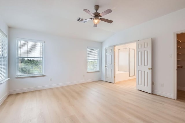 spare room featuring lofted ceiling, light hardwood / wood-style floors, and ceiling fan