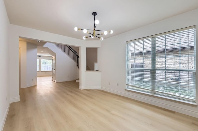 interior space featuring an inviting chandelier and light wood-type flooring