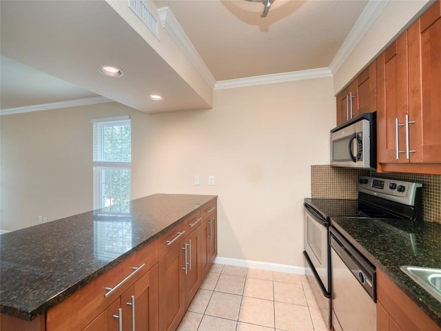 kitchen with stainless steel appliances, brown cabinets, visible vents, and ornamental molding