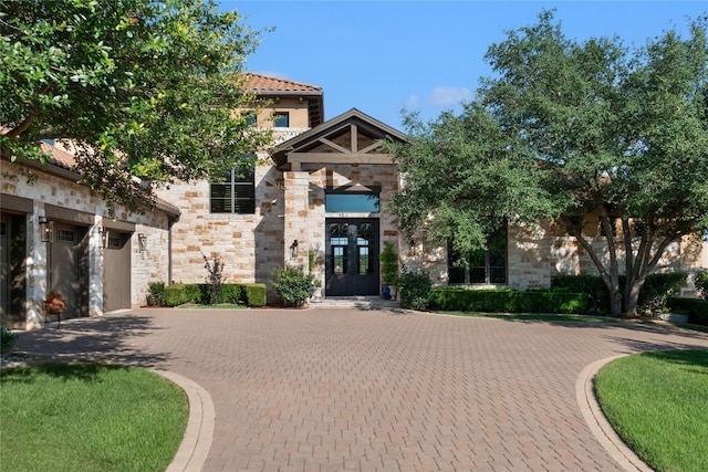 view of front facade featuring a garage and french doors