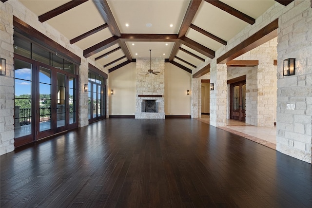 unfurnished living room featuring dark wood-type flooring, ceiling fan, beamed ceiling, and high vaulted ceiling